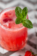 Fresh strawberry cocktail. Fresh summer cocktail with strawberry and ice cubes. Stawberry lemonade with leaves of mint.