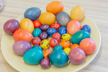 Easter holiday.colored eggs are on the table at the time of painting