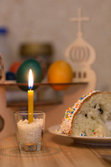 Easter holiday.colorful cakes are on the table .the candle burns