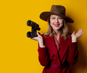 Woman in 1940s style clothes and binoculars