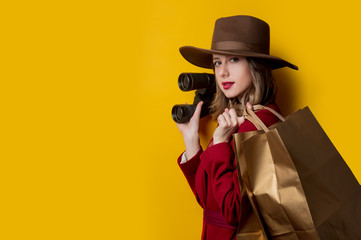 Woman in 1940s style clothes with binoculars and bags