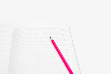 Blank notebook and pencils on white background. School supplies. White sketch book with colourful pencils. Note book and pencil