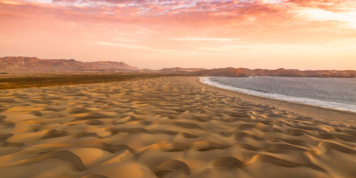 Sand dunes of the Peruvian desert at side of the Panamericana roadway