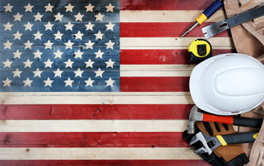 Labor Day concept with tools over distressed wooden United States Flag background