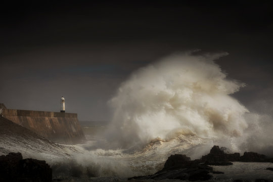 Porthcawl lighthouse and pier in the jaws of a storm on the coast of South Wales, UK. © leighton collins