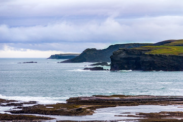 Fototapeta na wymiar Surrounding the seaside town of Kilkee, County Clare, Ireland are interesting cliffs with many unique rock formations