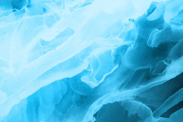 Hand painted blue alcohol ink background. Abstract delicate winter season texture. Contemporary wallpaper. 