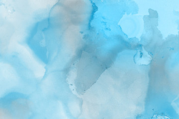 Fototapeta na wymiar Hand painted blue alcohol ink background. Abstract delicate winter season texture. Contemporary wallpaper. 