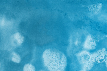 Hand painted blue alcohol ink background. Abstract delicate winter season texture. Contemporary wallpaper. 