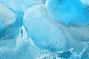 Hand painted blue alcohol ink background. Abstract delicate winter season texture. Contemporary wallpaper. 