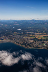 Aerial view of a small town, Parksville, on Vancouver Island during a sunny summer morning. Taken near Nanaimo, British Columbia, Canada.
