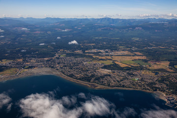 Aerial view of a small town, Parksville, on Vancouver Island during a sunny summer morning. Taken near Nanaimo, British Columbia, Canada.