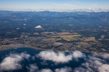 Aerial view of a small town, Parksville, on Vancouver Island during a sunny summer morning. Taken near Nanaimo, British Columbia, Canada.