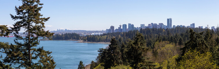 Obraz premium Aerial panoramic view of Stanley Park and Downtown City during a vibrant sunny day. Taken from Lions Gate Bridge, Vancouver, British Columbia, Canada.
