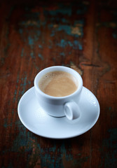 Cup of coffee on rustic wooden background. Copy space.