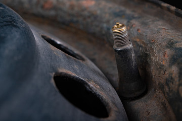 The valve in the car wheel. Replacement and service of tires in a passenger car.