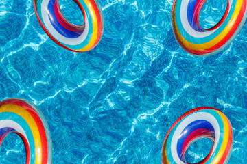 Inflatable water activities four circles tuba float on the water in the pool. banner, copy space.Concept, fun, perky summer and relaxation. - 283263937
