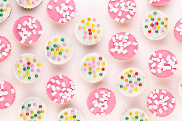 Colorful cupcakes on a white background.