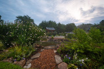 Pagoda in Garden with Flowered Walking Path and Blue Sky