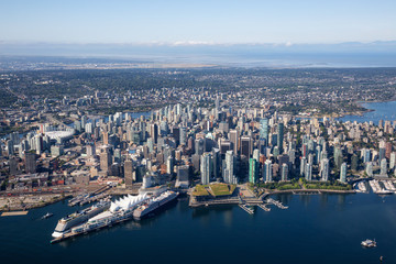 Aerial view of Downtown City, Port and Harbour in Vancouver, British Columbia, Canada. Taken during a sunny summer morning.