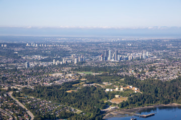 Obraz premium Aerial view of a modern cityscape during a sunny summer morning. Taken in Burnaby, Greater Vancouver, British Columbia, Canada.