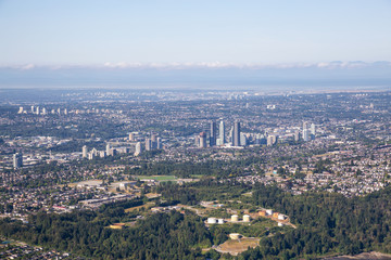 Obraz premium Aerial view of a modern cityscape during a sunny summer morning. Taken in Burnaby, Greater Vancouver, British Columbia, Canada.