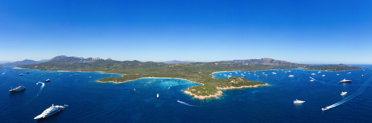 Stunning panoramic view of some beaches of the Emerald Coast (Costa Smeralda) with boats and luxury...