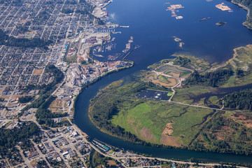 Aerial view of a small industrial town, Port Alberni, on Vancouver Island during a sunny summer morning. Located in British Columbia, Canada.