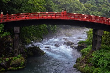 Shinkyo Bridge over the Daiwa River in Nikko outside of Tokyo, Japan in summer with cloud cover. Aisa.
