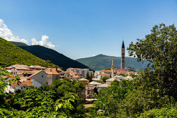 Fototapeta na wymiar A bell tower and a minaret in Mostar