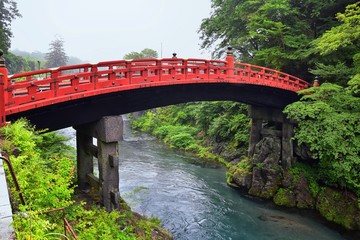 Shinkyo Bridge over the Daiwa River in Nikko outside of Tokyo, Japan in summer with cloud cover. Aisa.