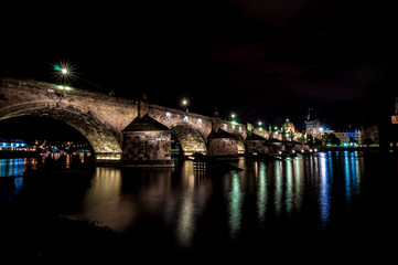 Fototapeta na wymiar Beautiful Charles Bridge (Karluv Most) with Old Town Tower (Staromestska mostecka vez) at night. Prague, Czech Republic