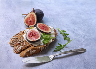 Open sandwich on dark bread with cream cheese and figs.