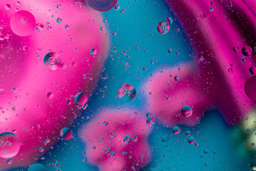 Micro molecular abstract pattern of colored oil bubbles on water. 