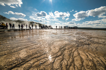 Tourists take a walk on geysers in Yellowstone National Park