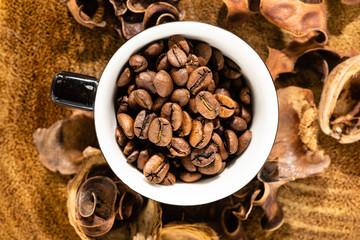 cup with coffee beans and rustic wooden background