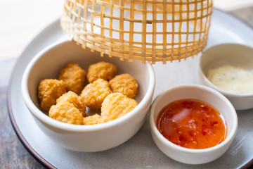 deep fried chicken nuggets with spicy sauce
