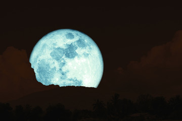 super full harvest moon on night sky back silhouette mountain