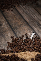 coffee beans on brown wooden background with text copy space