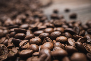 Close up coffee beans on brown wooden background