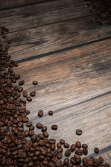 coffee beans on brown wooden background with text copy space
