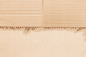 Brown corrugated or cardboard sheet texture paper torn backgroundof