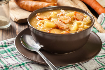 Traditional Polish split pea soup with sausage, bacon and potatoes