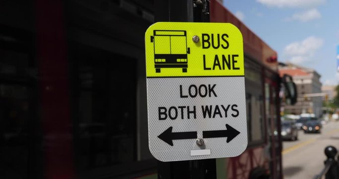 A bus lane warning sign for pedestrians crossing the street in Pittsburgh's Oakland neighborhood.  	