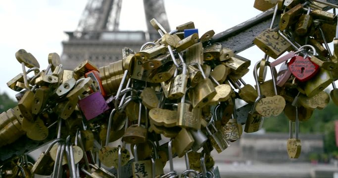 on the bridge in Paris against the Eiffel tower hang love locks.