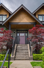 Entrance of luxury residential house with decorative red leave trees