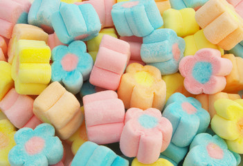 Many flower shaped marshmallow candies as background