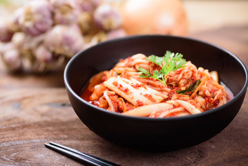 Kimchi cabbage in a bowl with chopsticks, Korean food