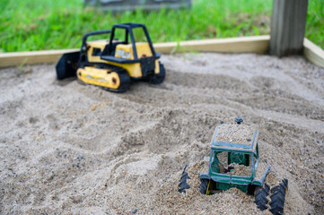 Vintage metal construction toys buried in sandbox © Lost_in_the_Midwest