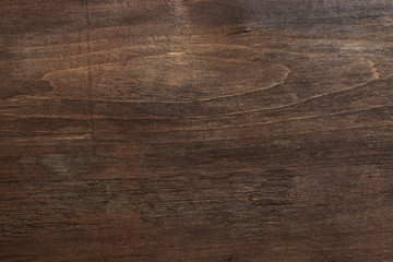 Shabby wood texture. Dark brown wooden background. Scratched wooden wall.
